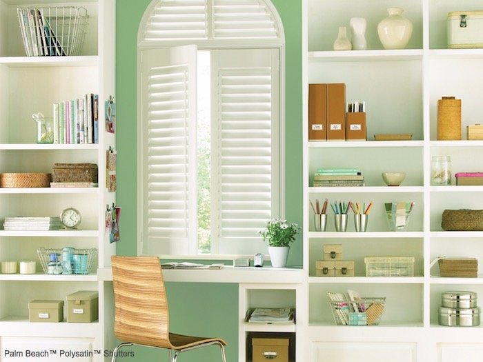 A green painted wall brings the outdoor into this home office. Shown with Palm Beach Polysatin Shutters, available at F & R Blinds, Inc in Los Angeles.